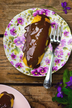 cake an eclair with chocolate cream. selective focus