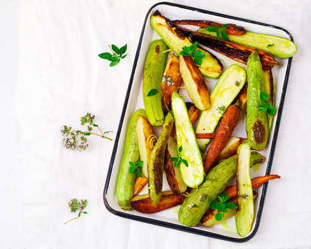 the baked summer vegetables in a baking sheet. style vintage. selective focusの写真素材