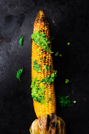 corn a grill with pesto sauce on a baking sheet. top view. style vintage. selective focus.の写真素材
