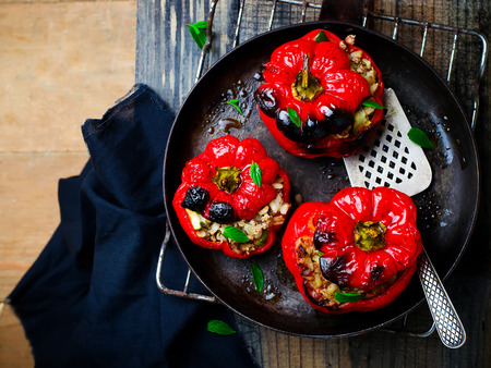 the sweet pepper stuffed with lamb and pearl barley in a vintage frying pan. style vintage. selective focusの写真素材