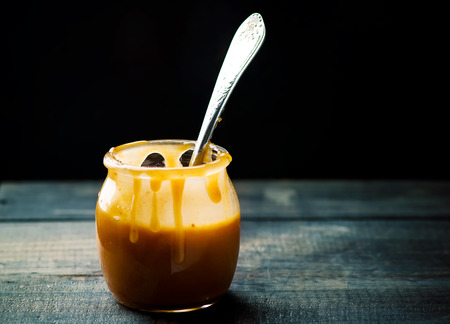 butter caramel in a glass jar. style vintage. selective focusの写真素材