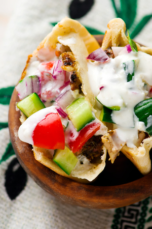 Gyros, the Greek sandwich with meat and fresh vegetables in a flat cake pita for picnic. selective focusの写真素材