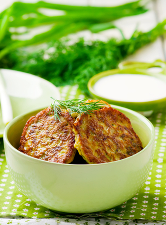 vegetable marrows fritters with sour cream on a green plate. selective focusの写真素材