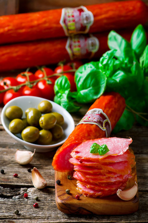 The cut salami sausage on a chopping board. Style rustic. Selective focusの写真素材