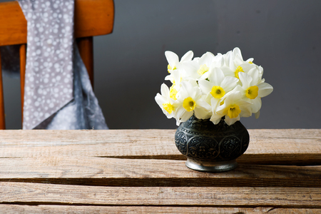 bouquet of narcissuses in vintage vase.style rustic.selective focusの写真素材