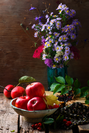Autumn still life with apples and flowers. style rustik. selective focus.の写真素材