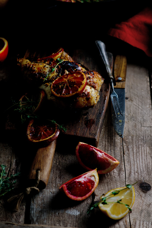 Lemon blood orange glazed roast chicken, style rustic, selective focusの写真素材