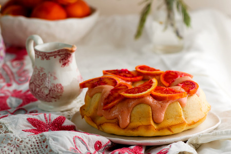 BLOOD ORANGE POUND CAKE WITH AN ORANGE ZEST ICING..vintage style.selective focusの写真素材