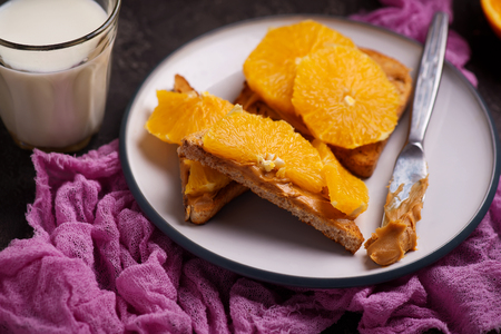 peanut butter toast with orange and milk .selective focusの写真素材
