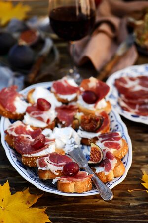 Crostini with cheese, prosciutto and fig. selective focusの写真素材