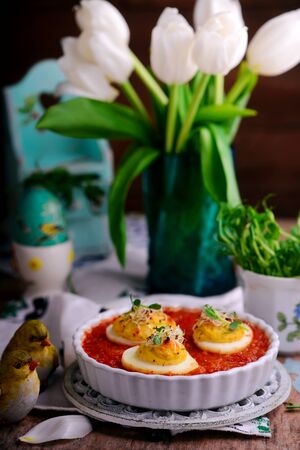 Baked Easter eggs in tomato sauce.style rustic.selective focusの写真素材