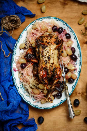 Pheasants with sauerkraut and grapes.style vintage.selective focus