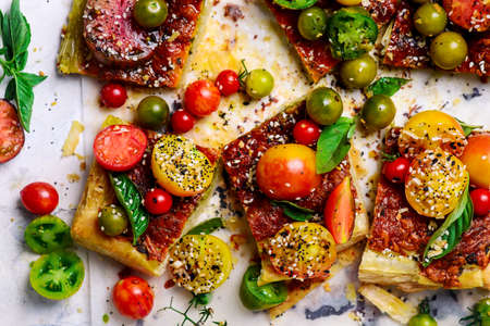 Cheese tomato and pesto tart.style rustic.selective focus