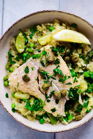 Risotto primavera with cod fillet .top veiw.style rustic.selective focus