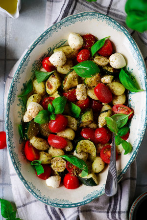 Italian Caprese salad with gnocchi and vegetables.. style vintage.selective focusの写真素材