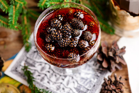 Jam from young pine cones in syrup on a background with pine branches.style rustic.selective focus