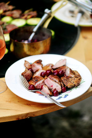 Duck Breast with Cherry Sauce on the outdoor grill.style rustic.selective focusの写真素材