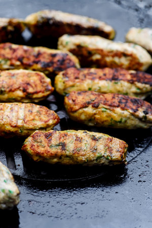 Chicken Lula Kebab with vegetables on the outdoor grill. .selective focus