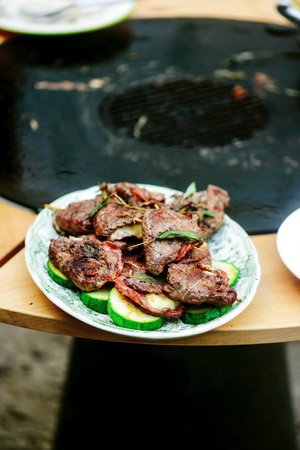 GGrilled veal picatta with vegetables on the outdoor grill .selective focus