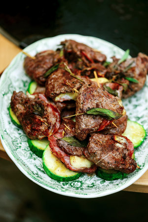 GGrilled veal picatta with vegetables on the outdoor grill .selective focus
