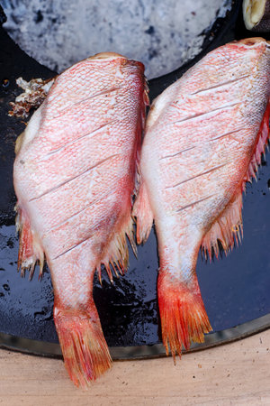 Grilled sea bass with herbal sauce on the grill..style rustic.selective focus