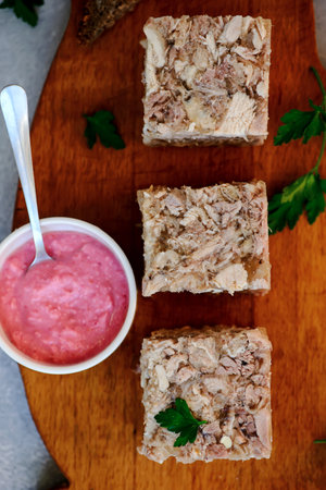 Jellied meat with horseradish on a wooden board. style hugge. selective focus