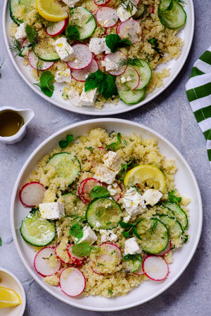 Fresh vegetable salad with couscous and fetain ceramic bowl.top veiw..selective focusの写真素材