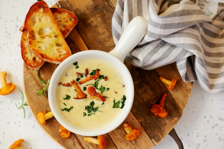 Creamy soup with chanterelles in a bowl..style hugge.selective focus