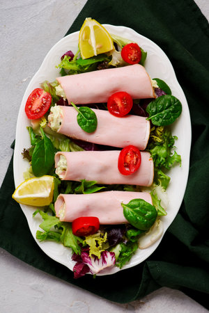 Snack rolls of ham with avocado and cream cheese for a breakfast. selective focusの写真素材