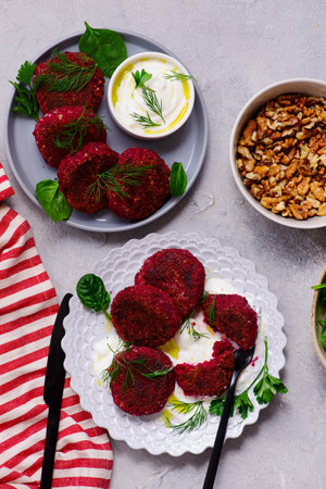 Beetroot and Walnut Vegan Cutlets with Yogurt Sauce and green salad.top veiw .selective focusの写真素材
