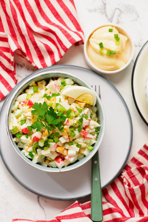 Traditional Russian salad with crab sticks, eggs and corn..top veiw. selective focusの写真素材