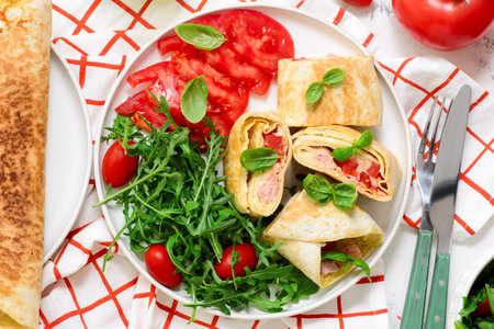 Tortilla roll with omelet, ham, cheese and tomato.top veiw. selective focusの写真素材