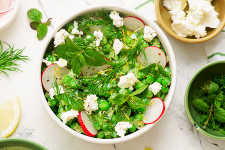 Spring Pea salad with radishes, feta and mint.in ceramic bowl.top veiw..selective focusの写真素材