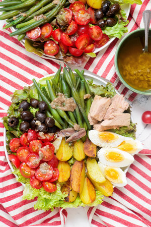 Nicoise salad with vegetables, tuna, eggs and anchovies.style hugge.top veiw.selective focusの写真素材