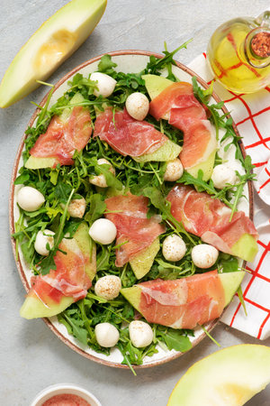 Melon Mozzarella Prosciutto Salad with Arugula.top veiw. selective focusの写真素材