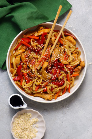 Udon noodles with chicken, vegetables and teriyaki sauce. top view. selective focusの写真素材