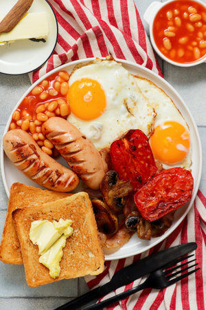 TRADITIONAL ENGLISH BREAKFAST WITH BUTTERED TOAST.TOP VEIW.selective focusの写真素材