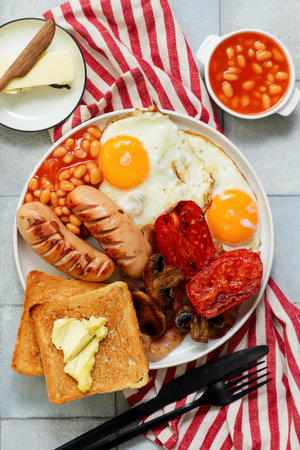 TRADITIONAL ENGLISH BREAKFAST WITH BUTTERED TOAST.TOP VEIW.selective focusの写真素材