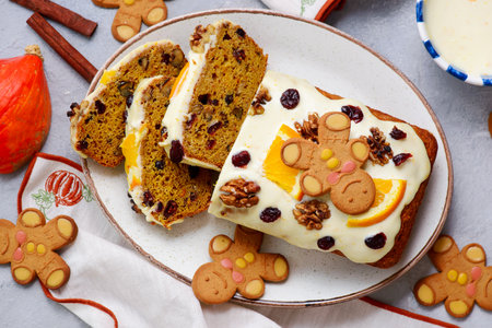 Pumpkin Christmas cake with dried fruits, spices and frosting on a Christmas rustic background.top...