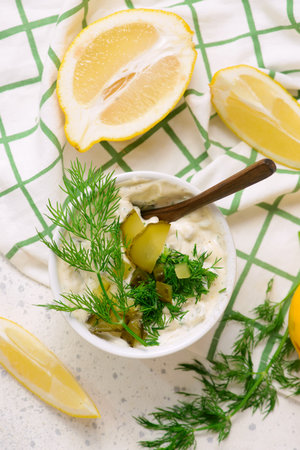 Tartar sauce with pickled cucumbers and dill in a bowl. top veiw.selective focusの写真素材