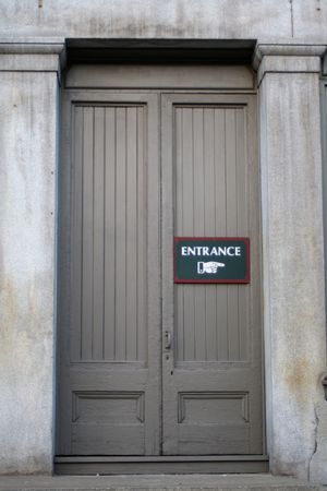 a gray door framed by gray stone columnsの写真素材