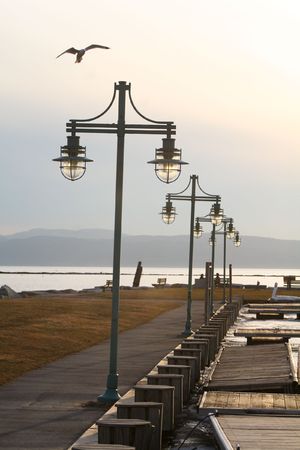 a row of lamp posts leading out to the watersideの写真素材