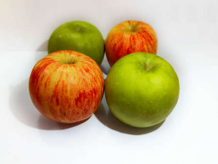 Two red apples and Two green apples on white backgroundの写真素材
