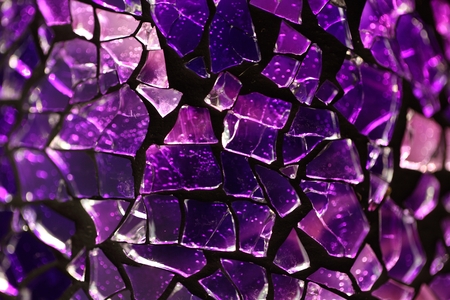 Purple glass fragments with a metal frame and backlight illumination.の写真素材