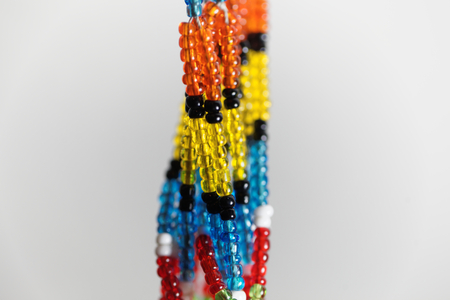 Macro photo of small beads with different colors on a string.