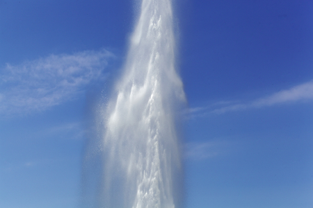 A water fountain with a blue sky.