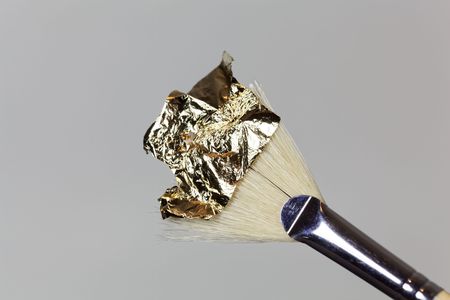 A brush with gold foil for gilding.の写真素材