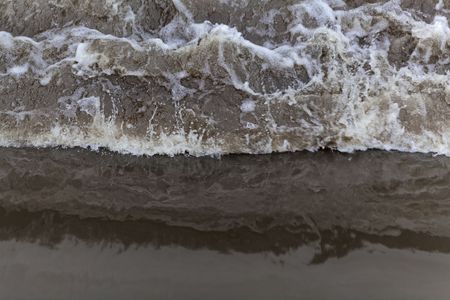 Turbulent brown water on a river weir.