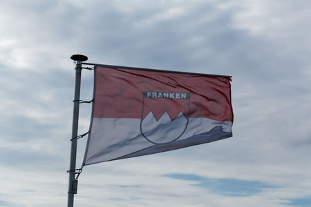 Flag of the German region Franconia with grey sky.の写真素材