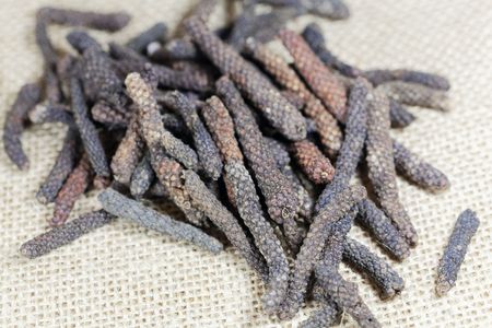 A macro photo of Long pepper (Piper longum)